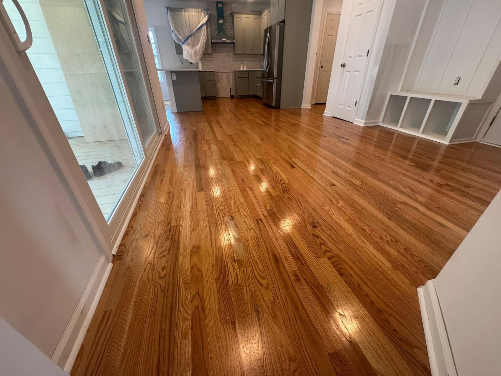 Refinished oak flooring in an open-concept kitchen and living area